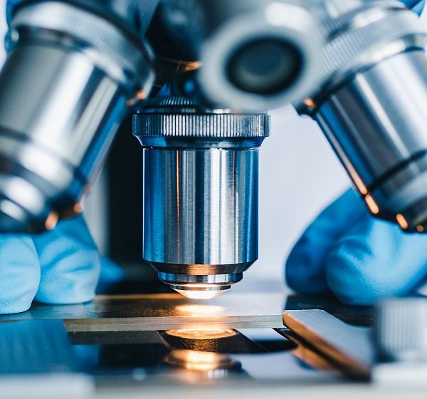 Close-up shot of microscope with metal lens at laboratory.